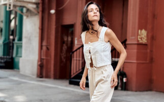 woman walking wearing a white top