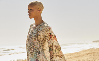 Woman walking across beach in coverup