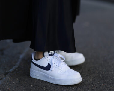 Clean, white sneakers with a black Nike Swoosh/