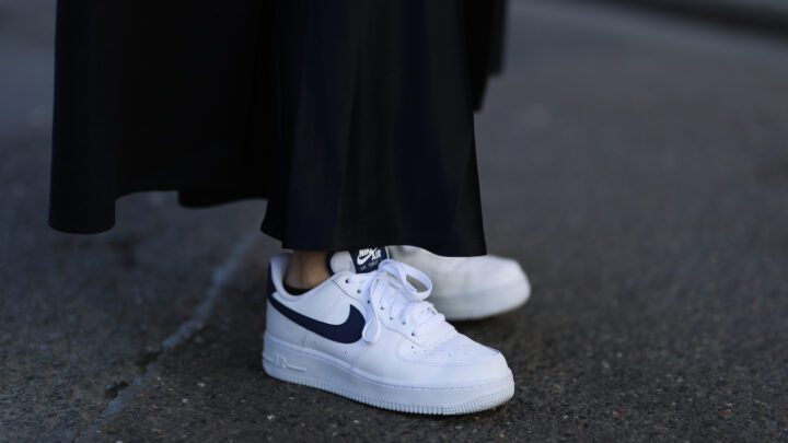 Clean, white sneakers with a black Nike Swoosh/