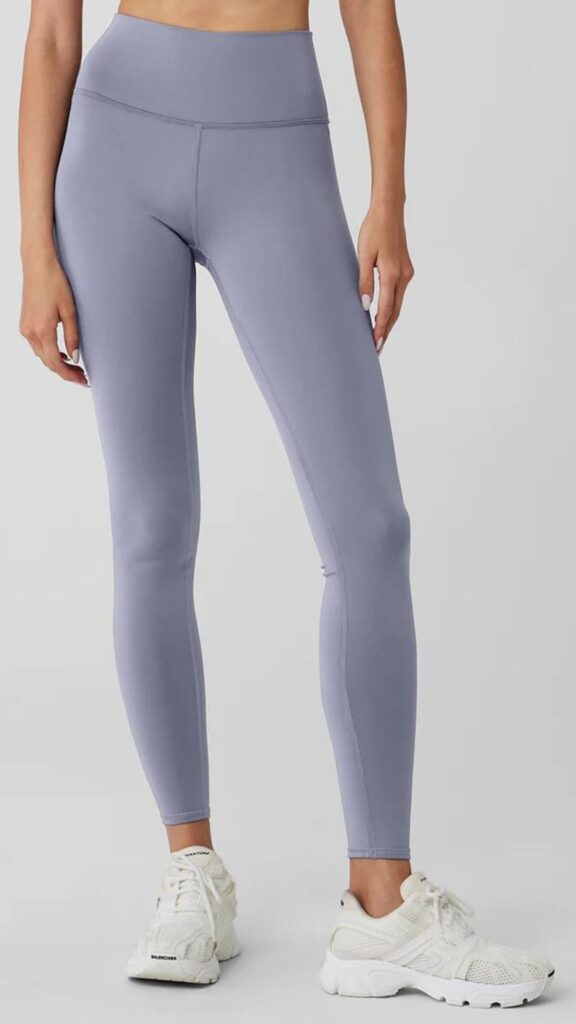 Alo Yoga Airlift Winter Warm High-Waist Legging ($235) are high compression with a bellybutton covering waist. This pair have an on trend faded lavender colour and are worn with white runners. 