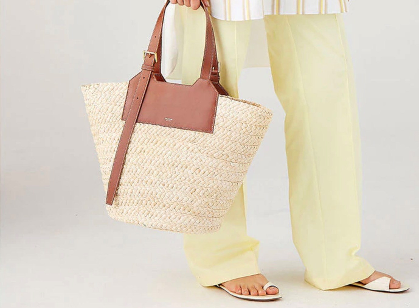A woven raffia tote gives of classic summer vibes, but you can also go for other totes if you want a less seasonal look.