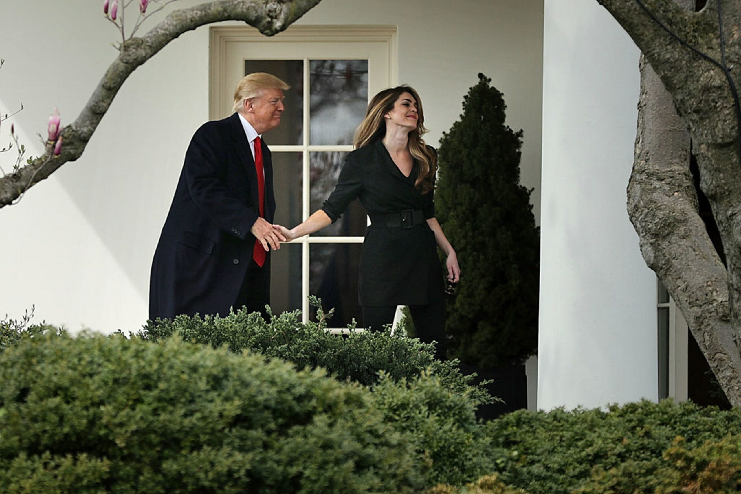 U.S. President Donald Trump shakes hands with Communications Director Hope Hicks