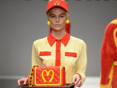 Woman carrying bag with logo that appears to McDonalds inspired