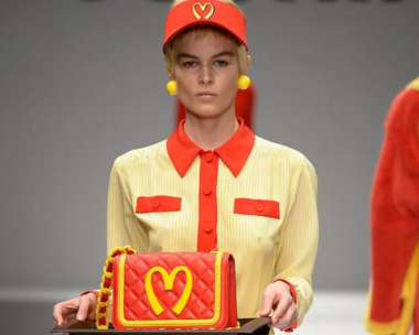 Woman carrying bag with logo that appears to McDonalds inspired