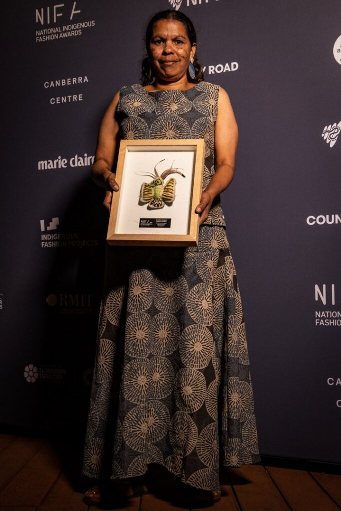 Rowena Morgan stands for a portrait with her Textile Design Award during the National Indigenous Fashion Awards 2023.

