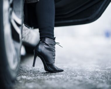 high heeled booted foot getting out of a car