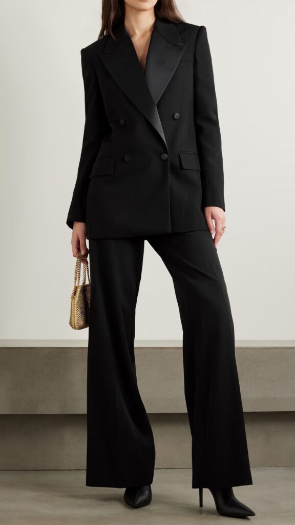 This black Stella McCartney is inspired by men’s tailoring, the practical coat features satin peak lapels, double-breasted buttons, and peaked shoulders for a striking silhouette. 