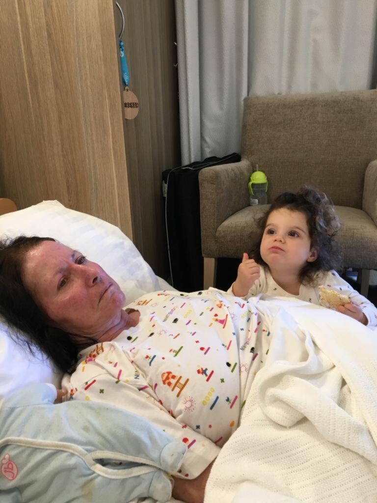 A woman battling alzheimer's in hospital with her grandaughter