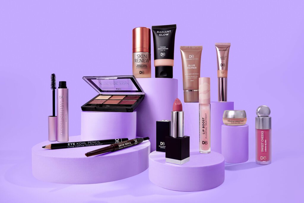 A range of cosmetics on a purple background.