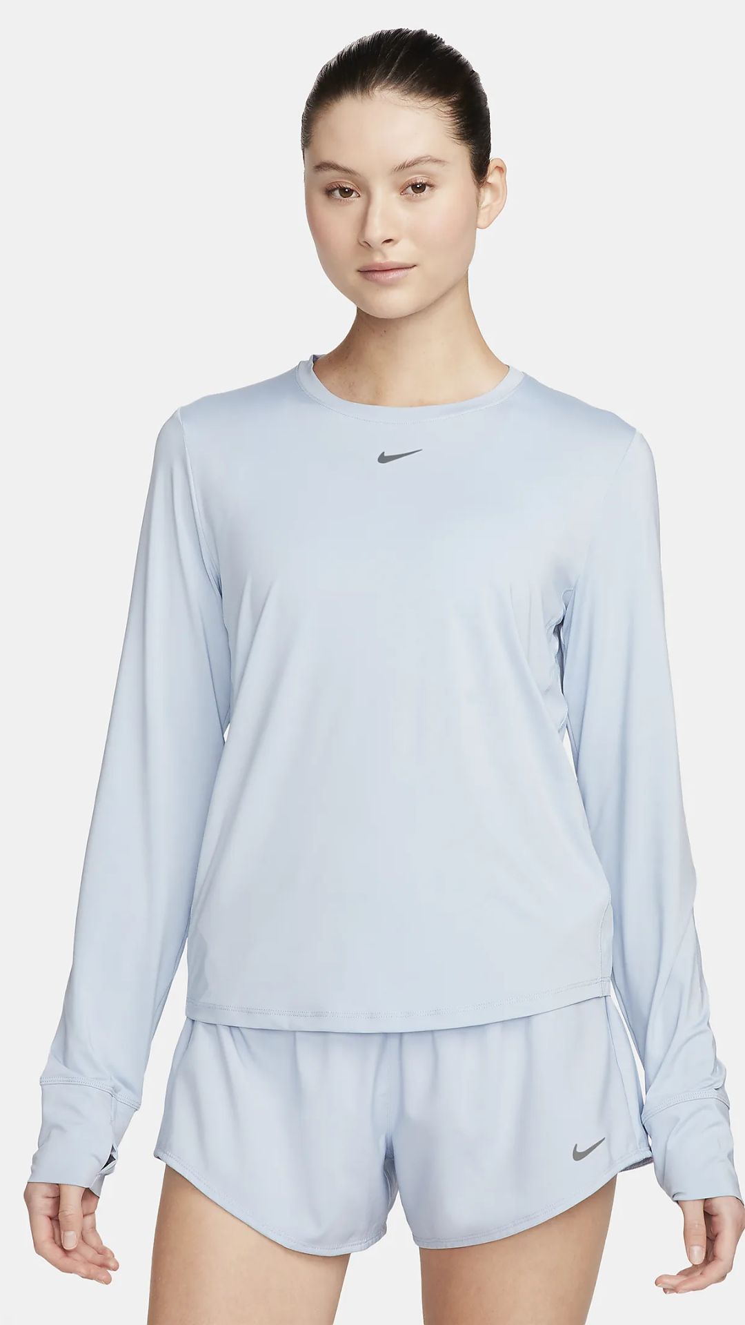 a woman wears a blue-white Long-sleeve Women's Activewear Top with a nike swoosh on it