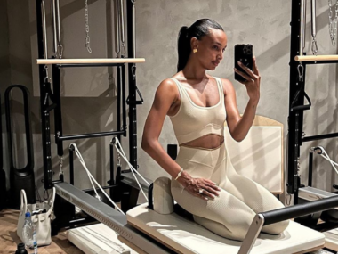 Model Jasmine Tookes on a reformer pilates machine