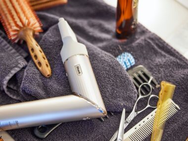 shark flexstyle hair styler with brushes and combs on a towel