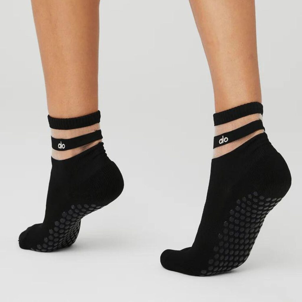 The Women's Pulse Grip Socks are crew style socks with ultra comfortable with terry cushioned toes for gripping the foot bar during pilates, compression ribbing over the foot arch and the grippiest of bottom grips. Other than comfort our favourite element here is the chic transparent mesh strip detail at the ankle. $48.00 from Alo Yoga. 
