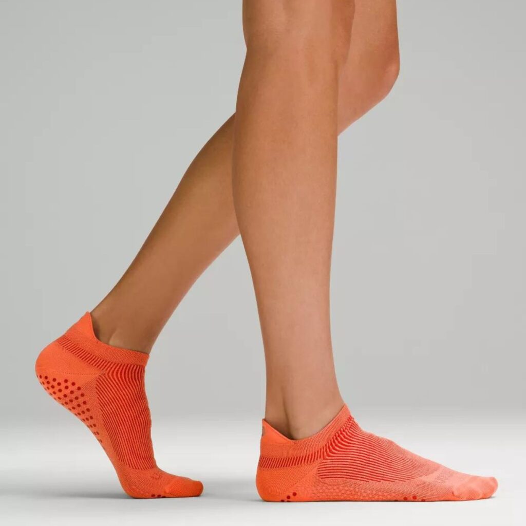 The Lululemon Find Your Balance Studio Tab Sock features grips along the inside and outside of the foot, not just the bottom, so you’ll feel confident and secure completing even the most complicated manoeuvre. The top of the foot features breathable mesh fabric for a sweat-free feel. Pictured here in vibrant Rasberry Cream, a orange sock with rasberry ribbing and grips. $25.00 at Lululemon.