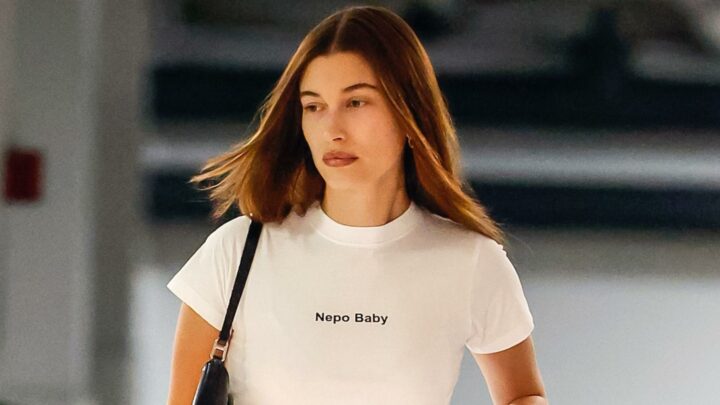 Hailey Bieber wears a white t-shirt that says 'nepo baby' on it.