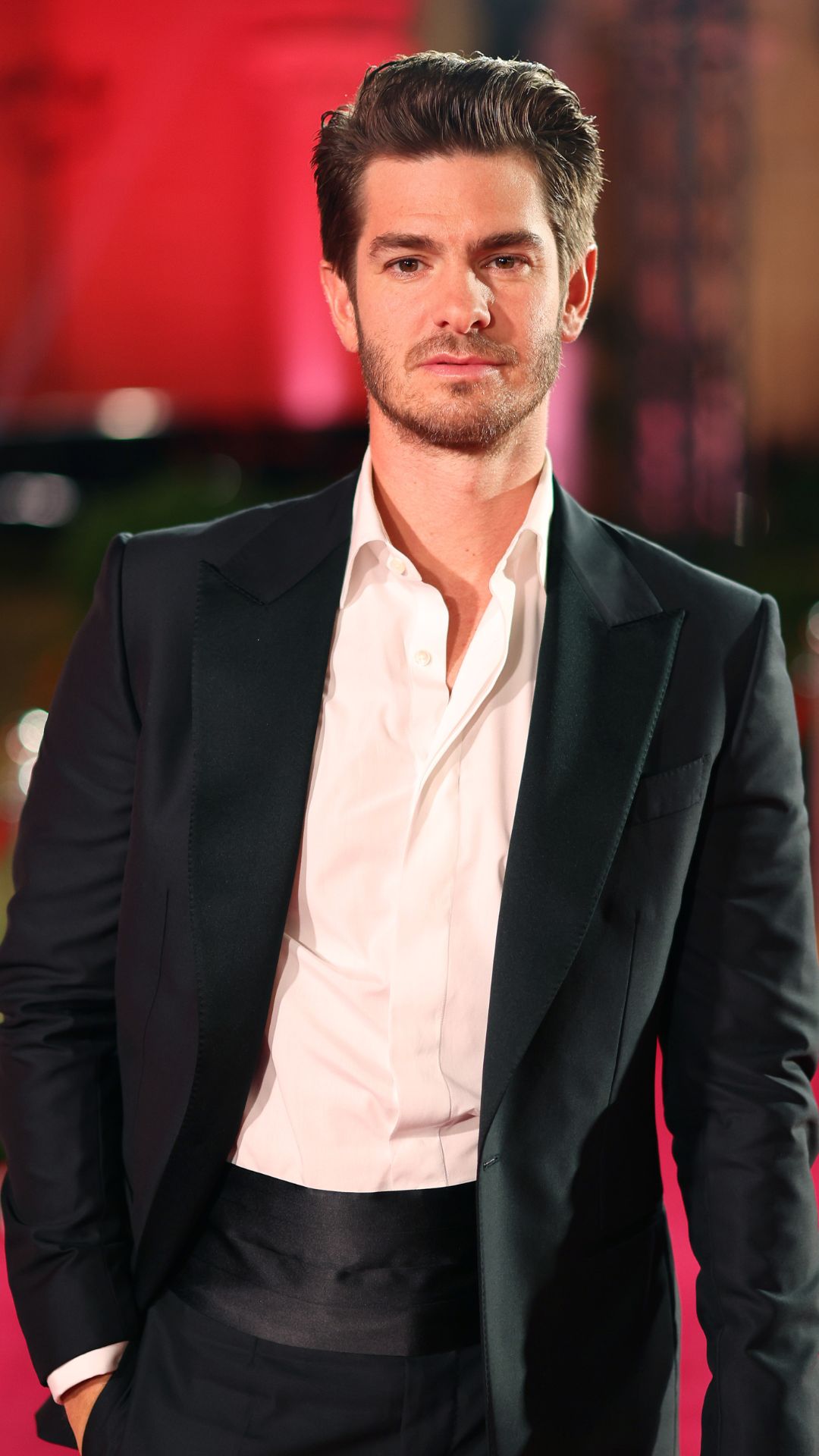 Andrew Garfield wears a black suit and white shirt