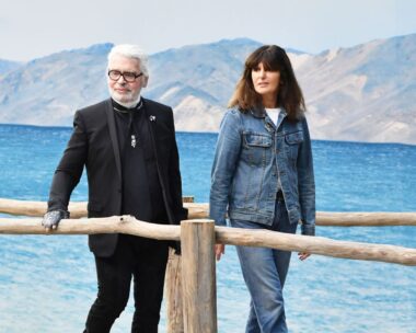 karl lagerfeld and virginie viard walk against the backdrop of the sea