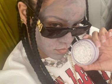 Rihanna wearing a face mask on a plane