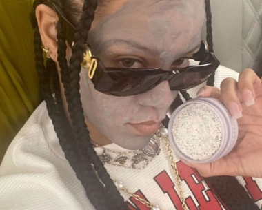 Rihanna wearing a face mask on a plane