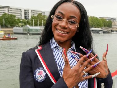 Sha'Carri Richardson poses for a photo while riding with teammates on a boat with teammates along the Seine River during the Opening Ceremony of the Olympic Games Paris 2024 on July 26, 2024 in Paris, France.