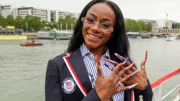 Sha'Carri Richardson poses for a photo while riding with teammates on a boat with teammates along the Seine River during the Opening Ceremony of the Olympic Games Paris 2024 on July 26, 2024 in Paris, France.