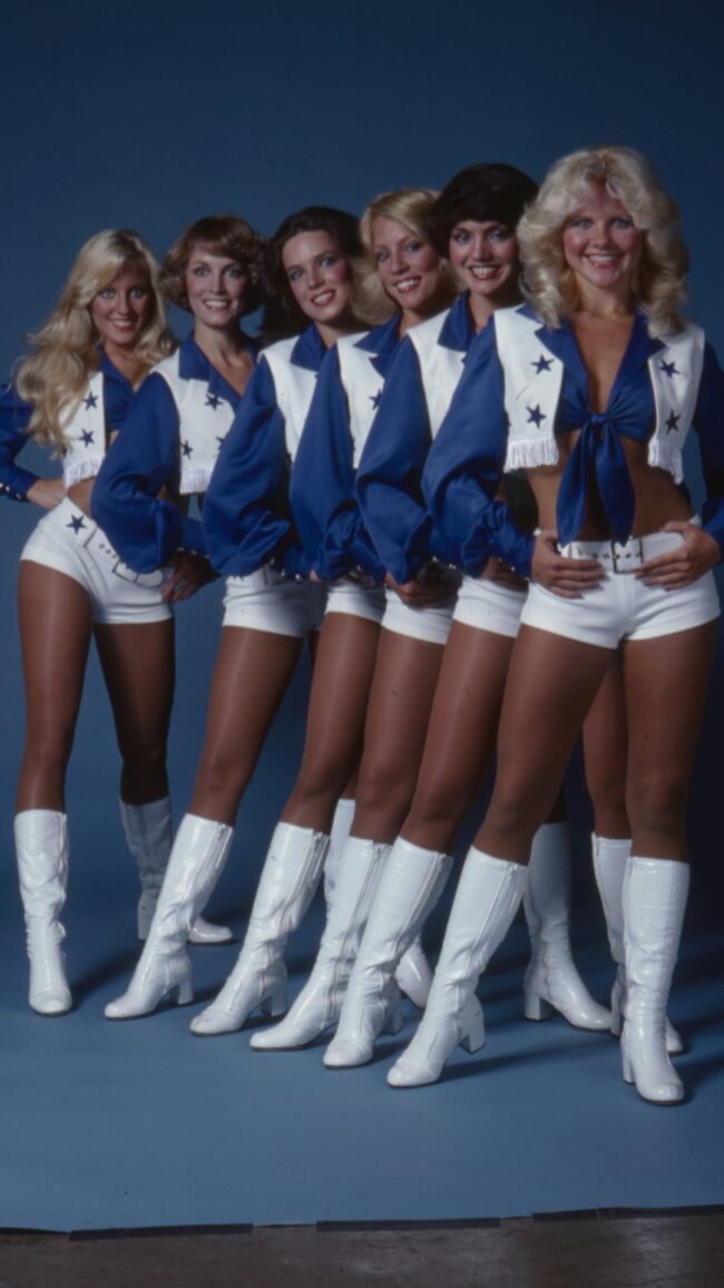 six dallas cowboys cheerleaders line up against a blue background in 1978