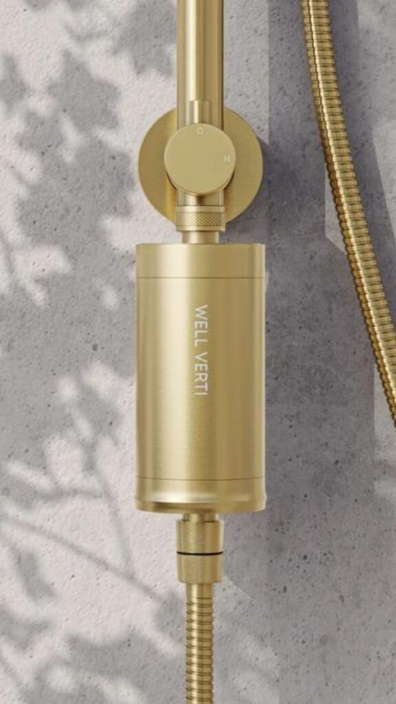 The Well Verti Shower water filter easily attaches to any shower set up, shown here in gold it is also available in black, white and silver.