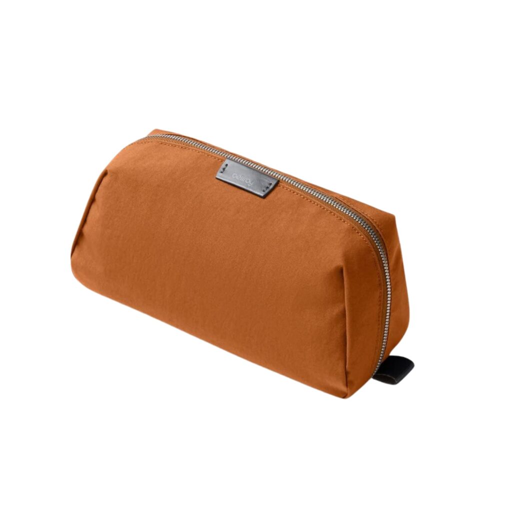 This small but mighty pouch features multiple zip compartments and pockets to secure mini travel items, toothbrushes, and medications while taking up minimal space in luggage. It is an essential for those wanting to travel light. Pictured here in Rust. 