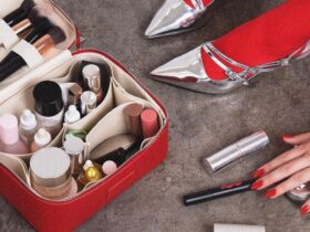 A woman with red stockings and silver heels packs her ultimate travel case for toiletries.