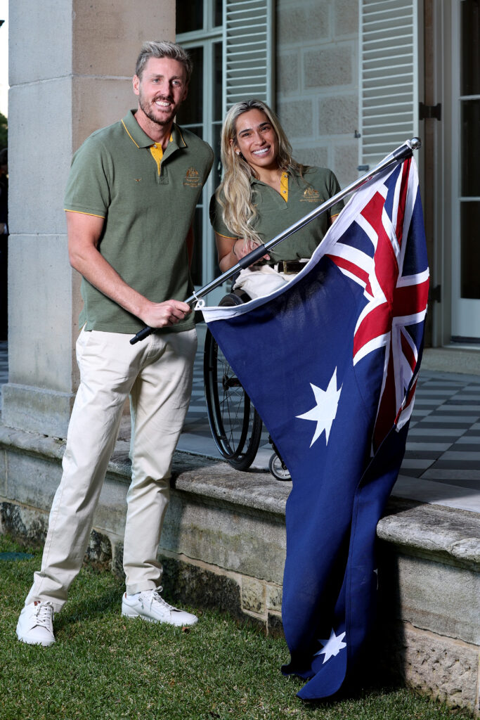 Madison de Rozario and Brenden Hall pose with the Australian flag 