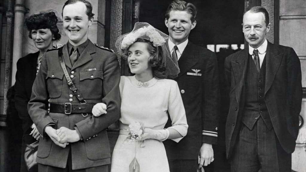 The marriage between the Marquis of Hartington, Coldstream Guards, Elder son of the Duke and Duchess of Devonshire, and Kathleen Kennedy, second daughter of the Hon. Joseph P. Kennedy, former ambassador in London, took place at the Chelsea Registry Office in London. Pictured after the ceremony are the bride and groom with the groom's father and mother and the bride's brother, Lieutenant Joseph Kennedy, USN, second from right.