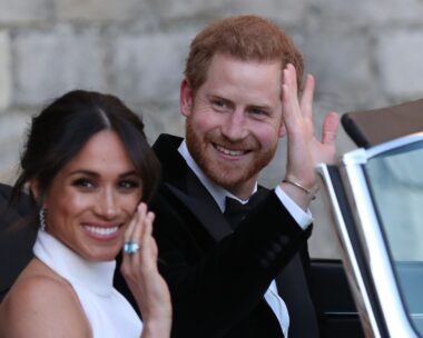 Duchess of Sussex and Prince Harry, Duke of Sussex wave as they leave Windsor Castle after their wedding to attend an evening reception at Frogmore House, hosted by the Prince of Wales on May 19, 2018 in Windsor, England.