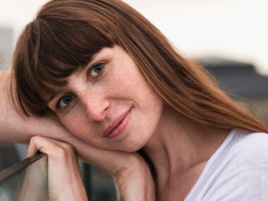 Woman's head leaning over her arm