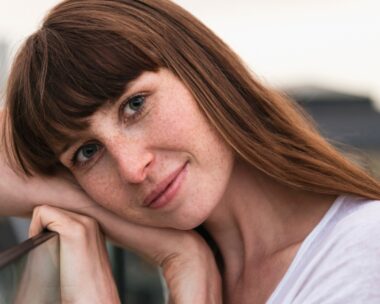 Woman's head leaning over her arm