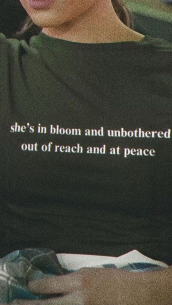 Jennifer Lopez wears a t-shirt that reads she's in bloom and unbothered out of reach and at peace 