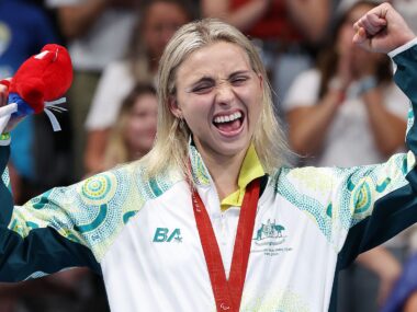 Australian para swimmer Alexa Leary celebrates on the podium after winning gold in the women's 100 metre freestyle.