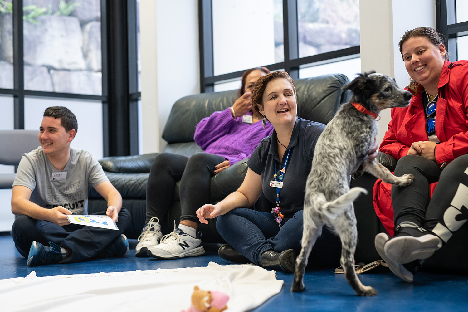 group of people sitting with a dog