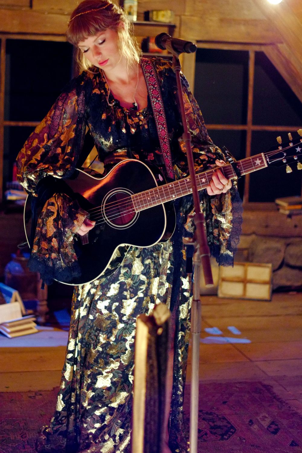 Taylor Swift performing in an intimate space during her Folklore era between 2020-2022.