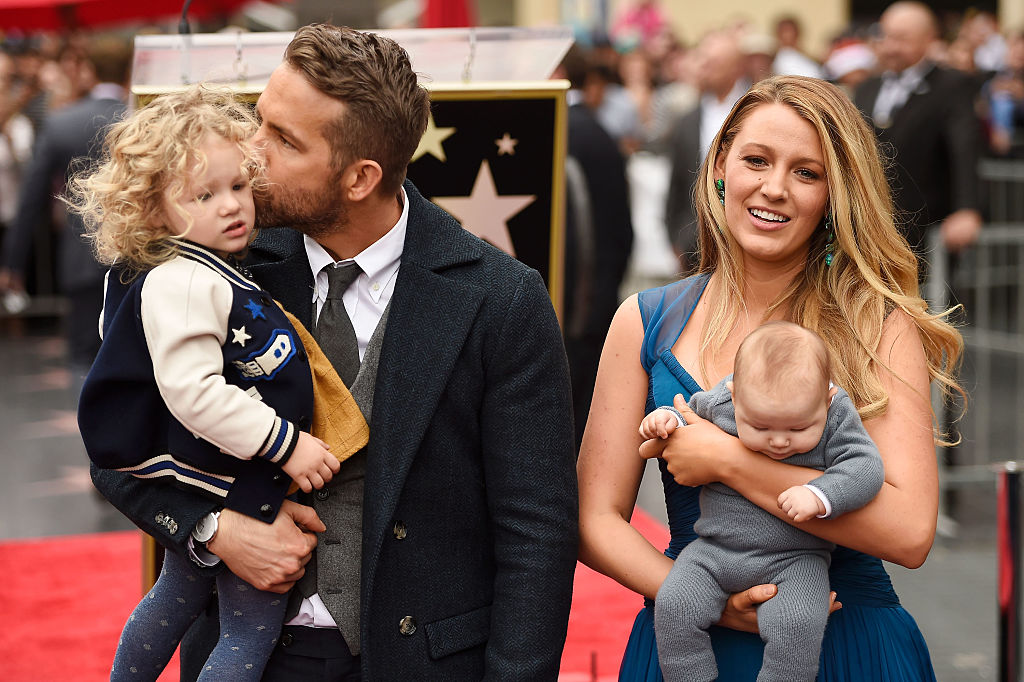 Ryan Reynolds (L) and Blake Lively pose with their daughters
