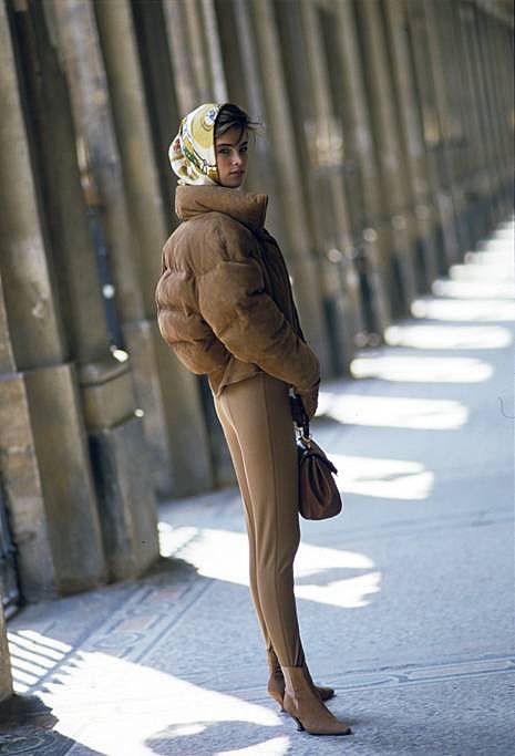 Lady wearing beige stirrup pants and puffer jacket
