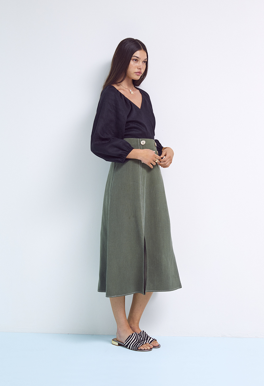 lady in navy blouse khaki skirt