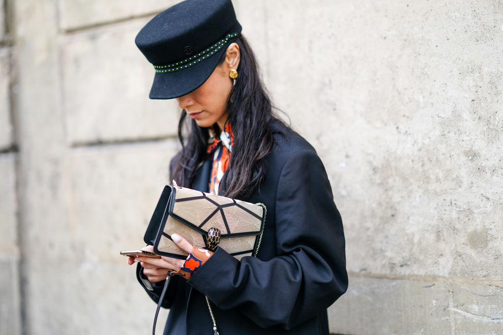 A woman looking down at her phone