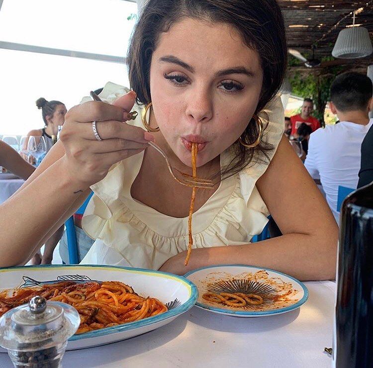 Selena Gomez eating pasta.