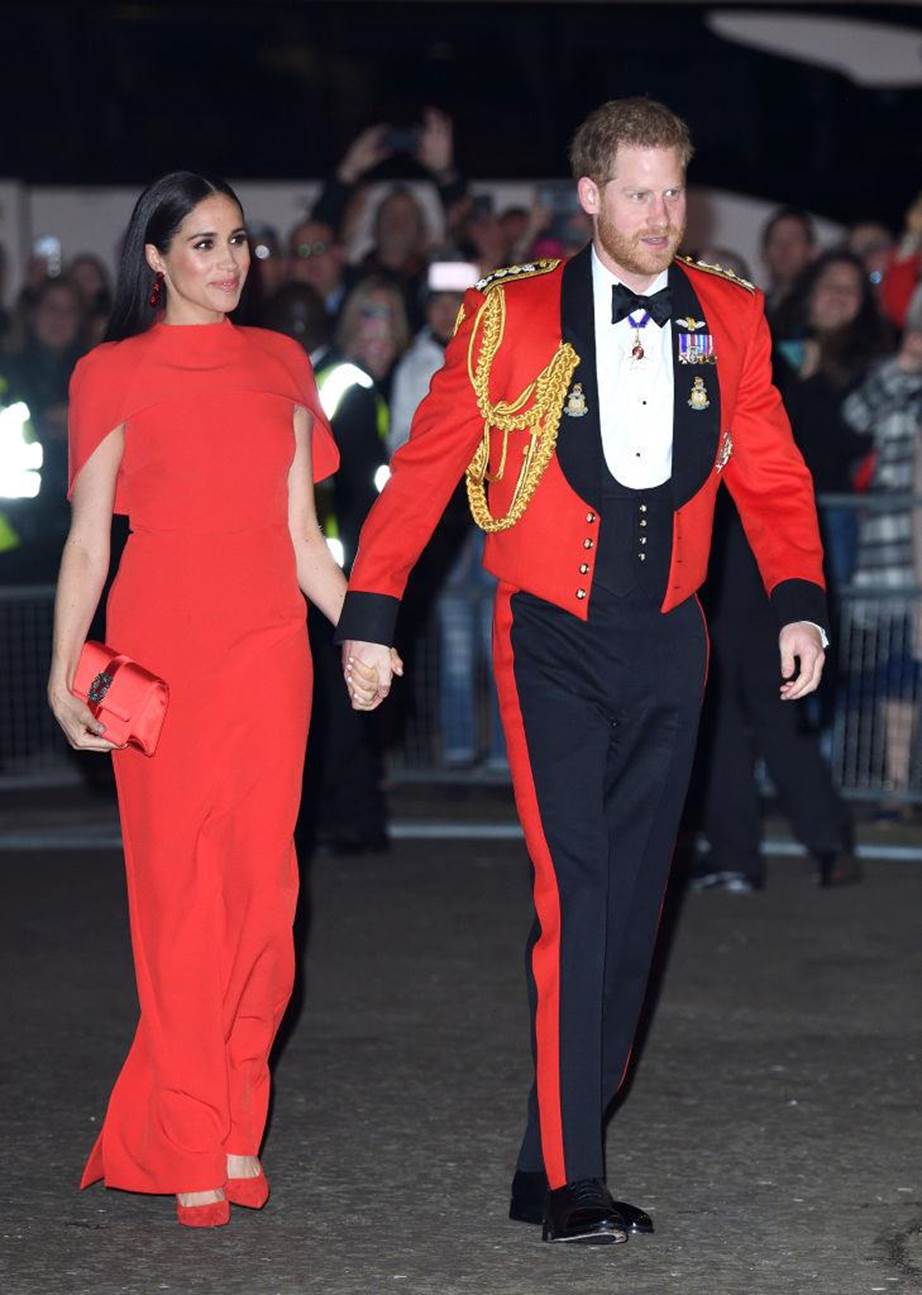 Meghan Markle and Prince Harry matching in red at the 2020 Mountbatten Festival of Music