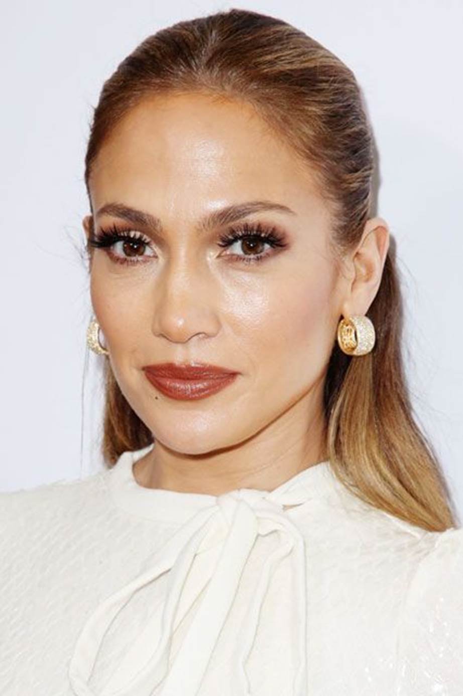 JLo attended a premiere in 2016 sporting her go-to bronze smokey eye and nude glossy lips
