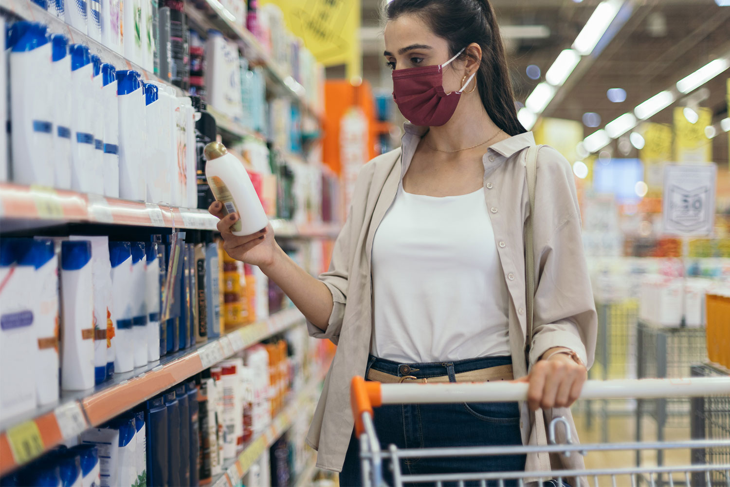 woman in supermarket with mask